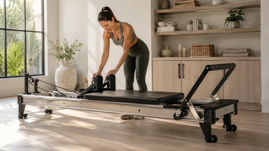 Foldable Pilates reformer machine in a modern home workout space with a compact and space-saving design