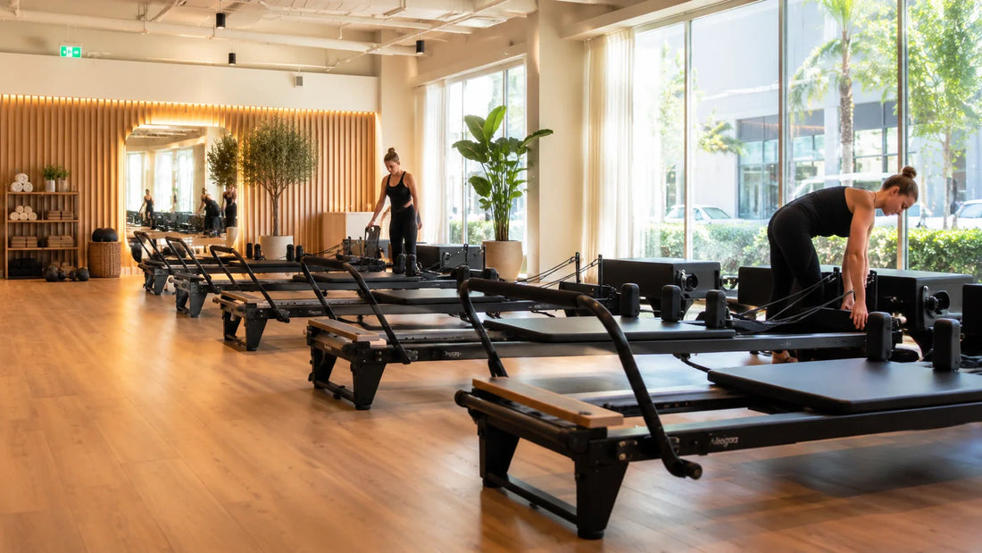 Modern Pilates studio with six reformer machines arranged in a spacious and professional workout environment