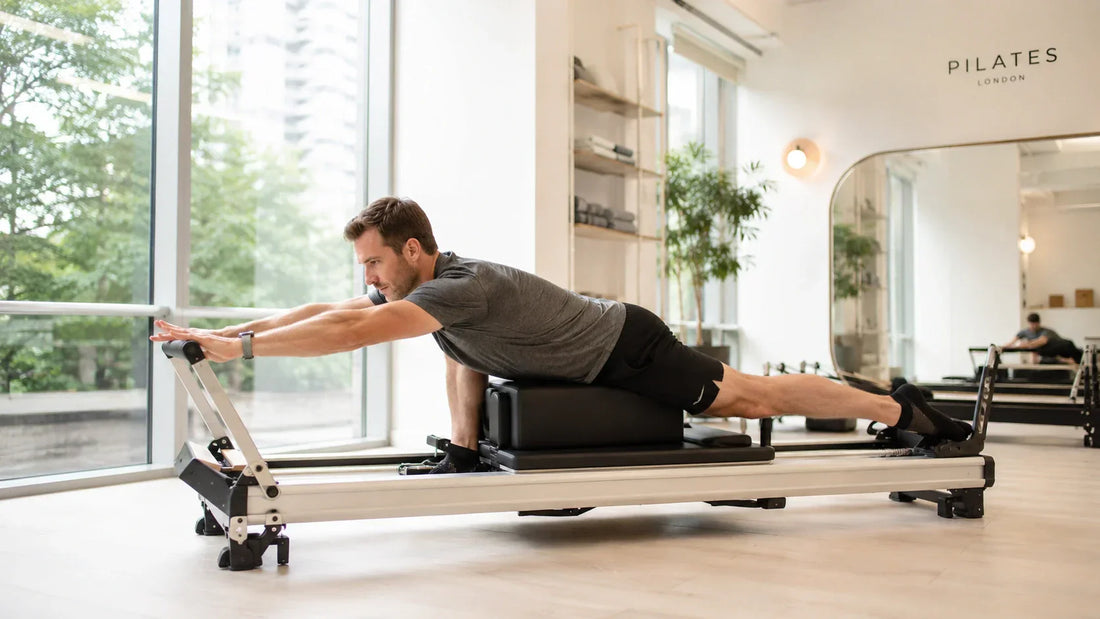 Person stretching on a reformer Pilates machine to improve flexibility and mobility in a modern studio